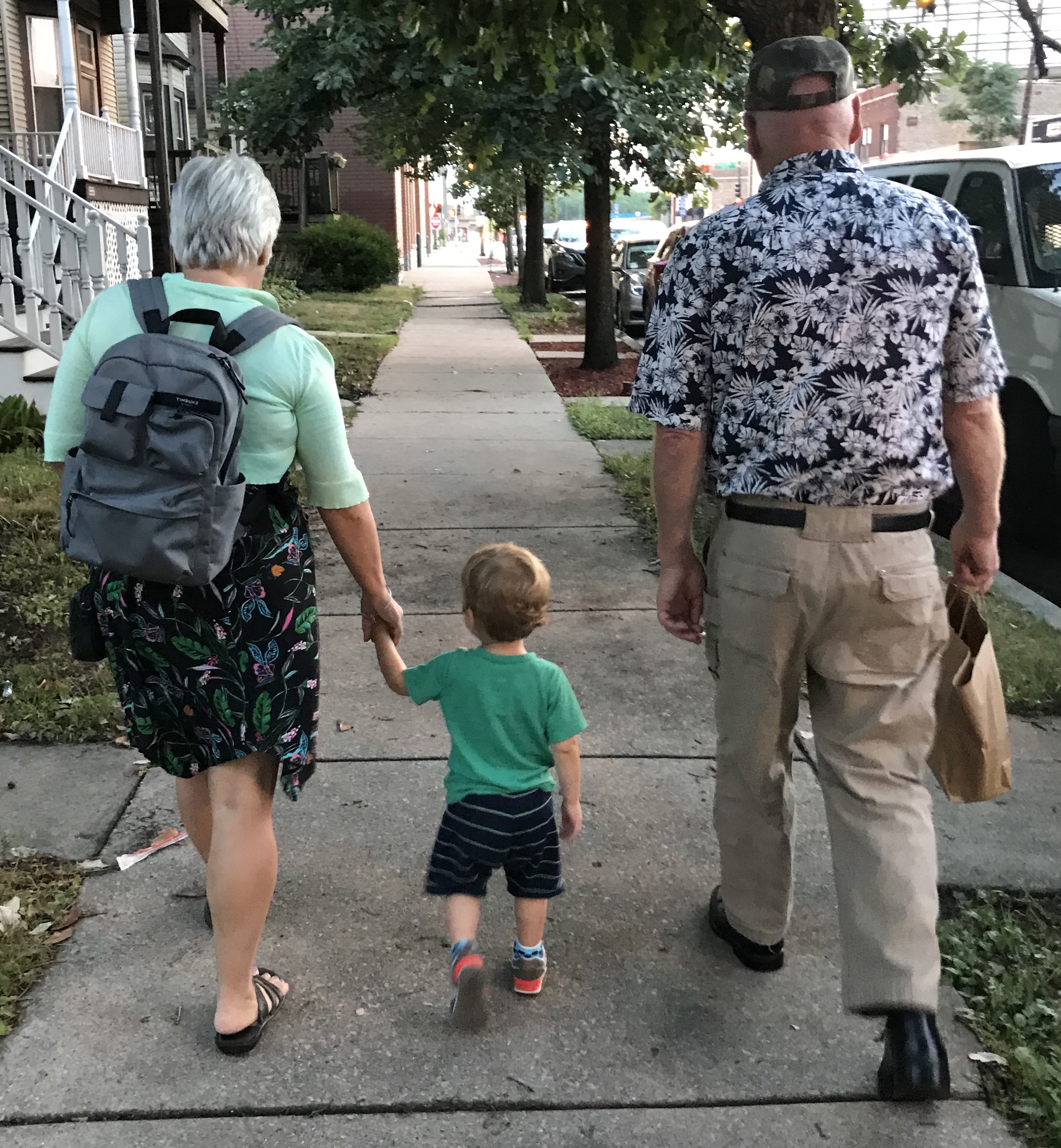 Grandmother and Grandfather walking with Grandson