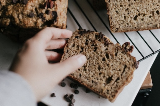 Hand Reaching For Chocolate Chip Loaf